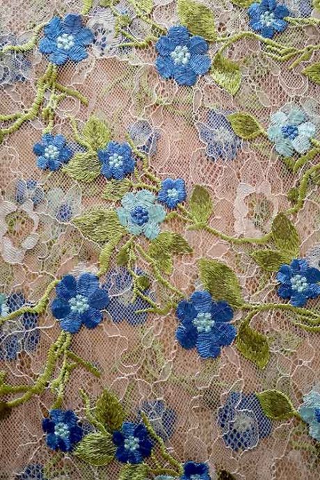 Scallop-edge tulle with embroidered flowers in blue and green