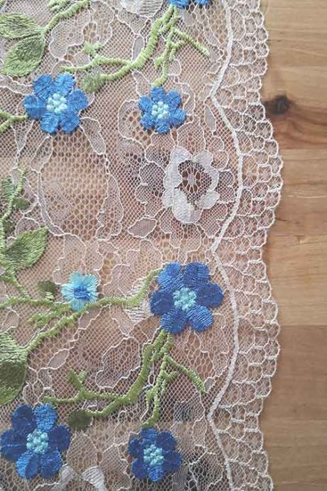 Scallop-edge tulle with embroidered flowers in blue and green